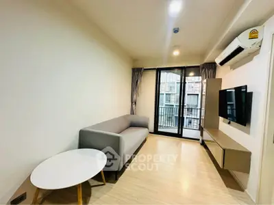 Modern living room with sleek furniture and balcony view in urban apartment