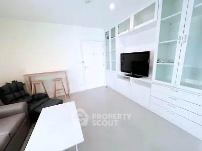 Modern living room with sleek built-in cabinets and cozy seating area.
