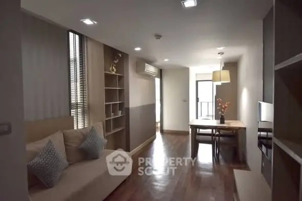Modern living room with cozy seating and dining area, featuring stylish decor and ample natural light.