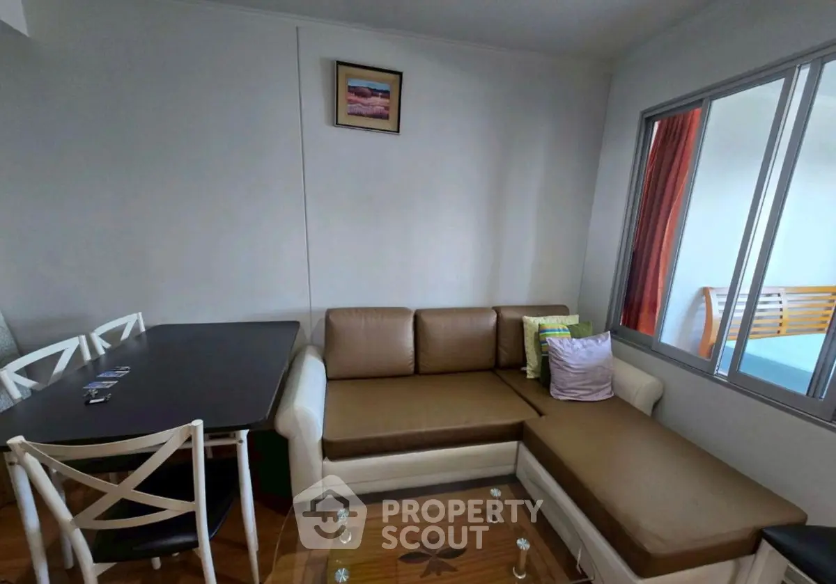 Cozy living room with modern furniture and dining area, perfect for relaxation and entertaining.