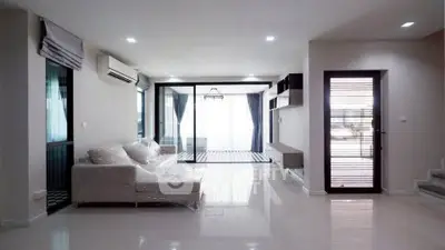 Spacious modern living room with large windows and sleek design