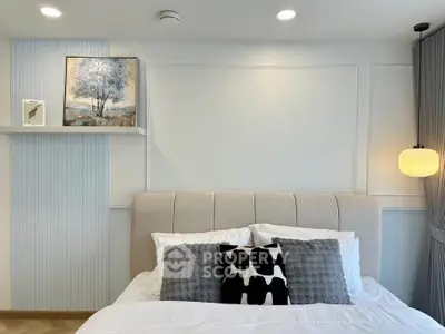 Modern bedroom with stylish decor and cozy ambiance, featuring elegant wall art and plush bedding.