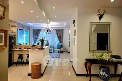Elegant open-layout living room with stylish decor and modern kitchen area