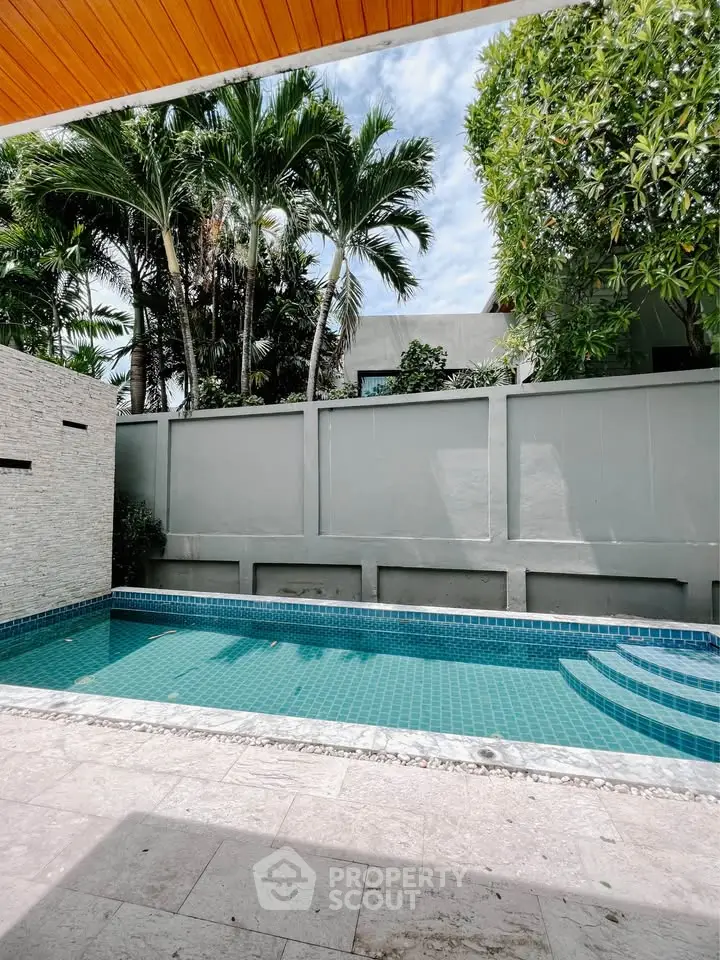 Luxurious private pool with tropical landscaping and modern design