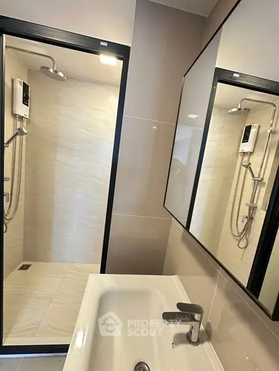 Modern bathroom with sleek shower and stylish sink in contemporary design.