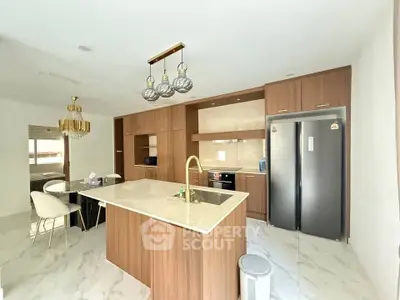 Modern kitchen with island and sleek appliances in a stylish open layout.