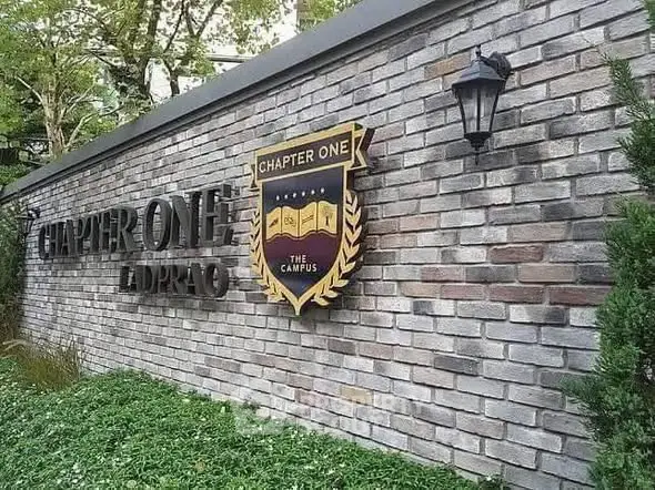 Elegant brick exterior of Chapter One Ladprao with lush greenery and stylish lighting.