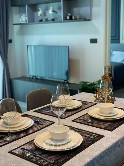 Elegant dining area with modern table setting and stylish decor in a contemporary living space.