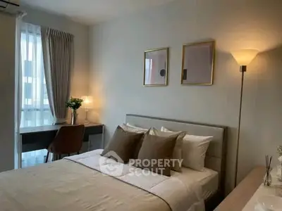 Cozy bedroom with modern decor and natural light, perfect for relaxation and comfort.