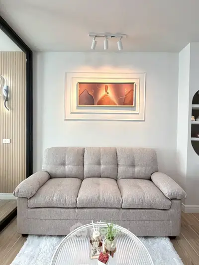 Stylish living room with cozy sofa and modern art decor