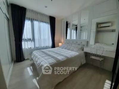 Elegant bedroom with modern decor and large windows for natural light