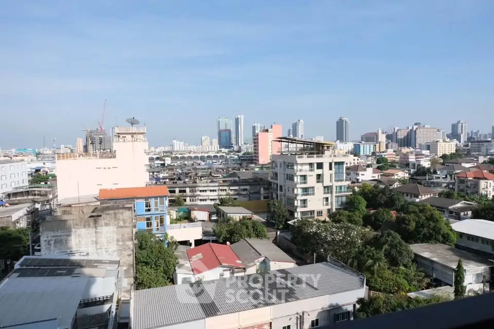 Stunning cityscape view from a high-rise building showcasing urban skyline and greenery.