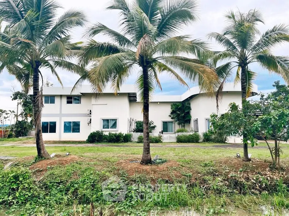 Stunning tropical property with lush greenery and palm trees, perfect for serene living.