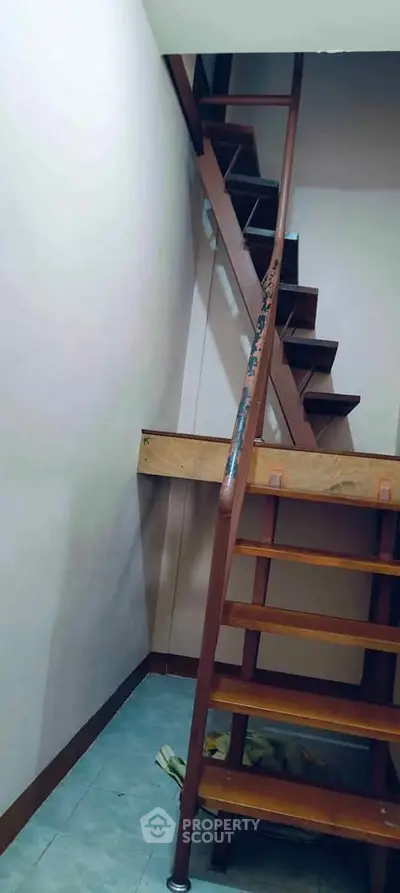 Compact wooden staircase in a minimalist interior space