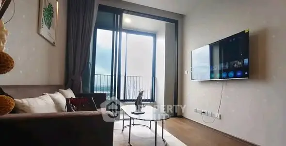 Modern living room with balcony view and wall-mounted TV in stylish apartment.