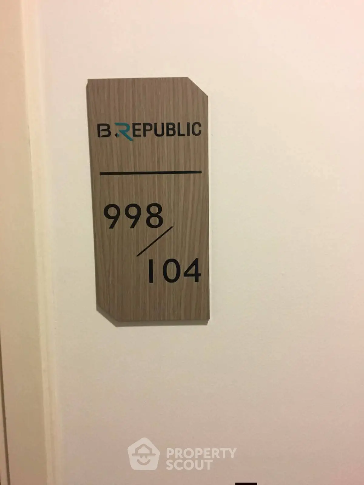 Modern apartment door sign with unit numbers and stylish design.
