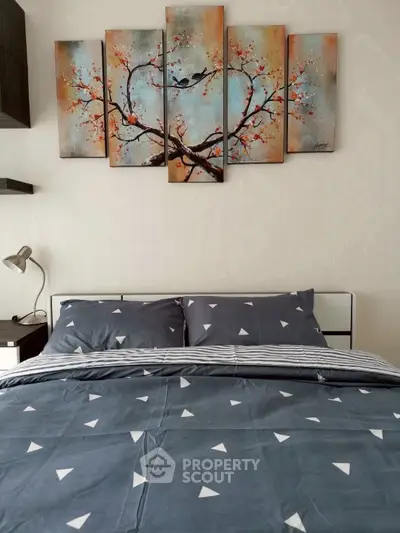 Cozy bedroom with stylish bedding and artistic wall decor
