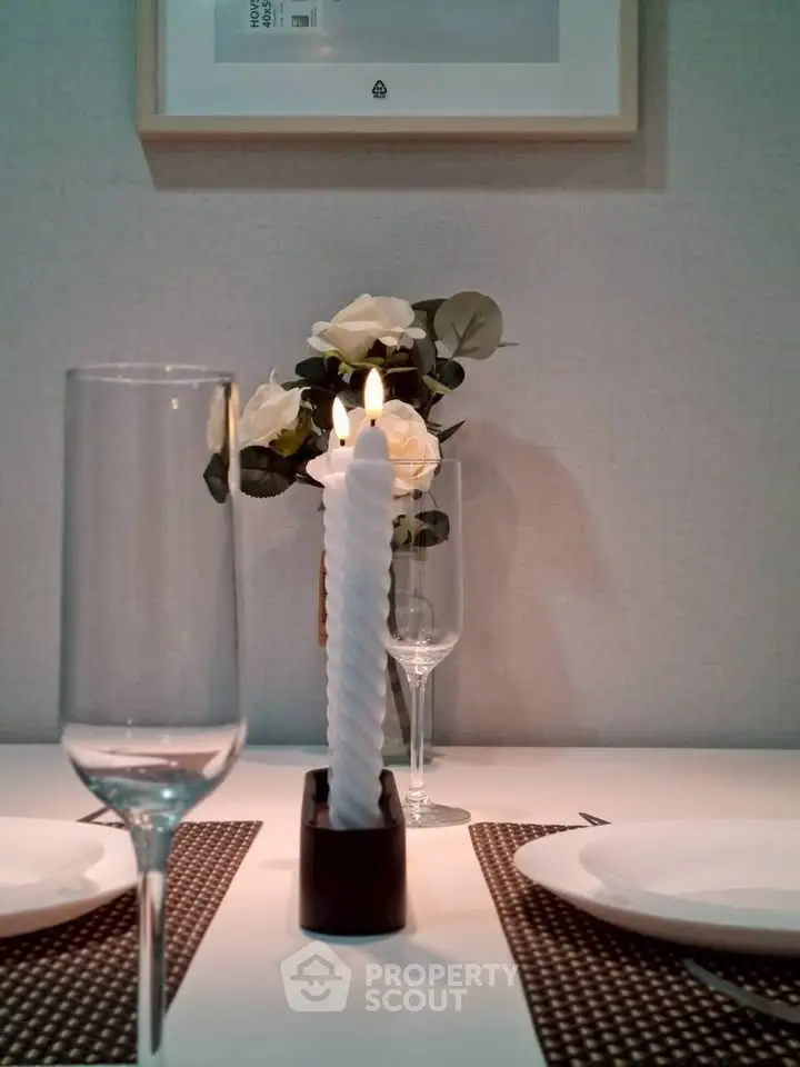 Elegant dining setup with candles and roses, perfect for intimate dinners.