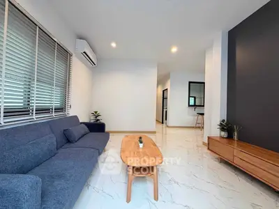 Modern living room with sleek furniture and stylish decor in a contemporary home.