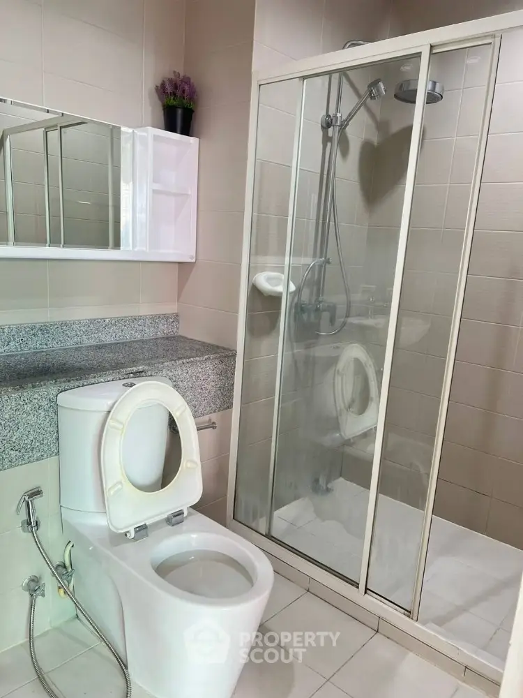 Modern bathroom with glass shower and sleek fixtures