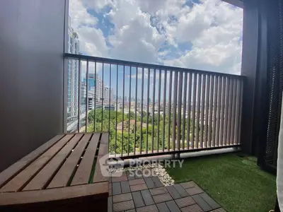 Charming balcony with lush green view and wooden seating, perfect for relaxation.