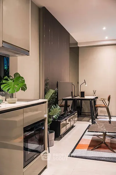 Modern living room with stylish decor and workspace, featuring sleek furniture and vibrant accents.