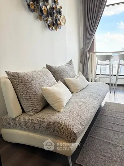 Modern living room with stylish sofa and city view from window