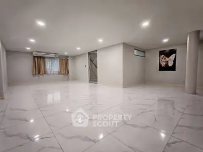 Spacious modern living room with marble flooring and elegant lighting
