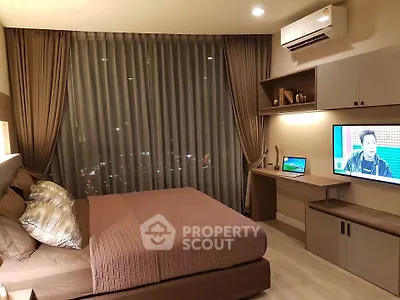 Modern bedroom with city view, featuring stylish decor and built-in desk area.
