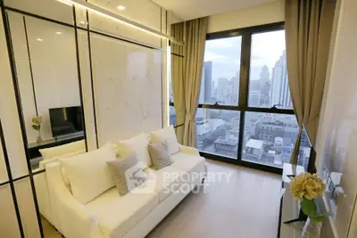 Modern living room with city view, elegant decor, and large windows in a high-rise apartment.