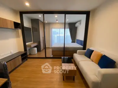 Modern studio apartment with glass partition and stylish furnishings