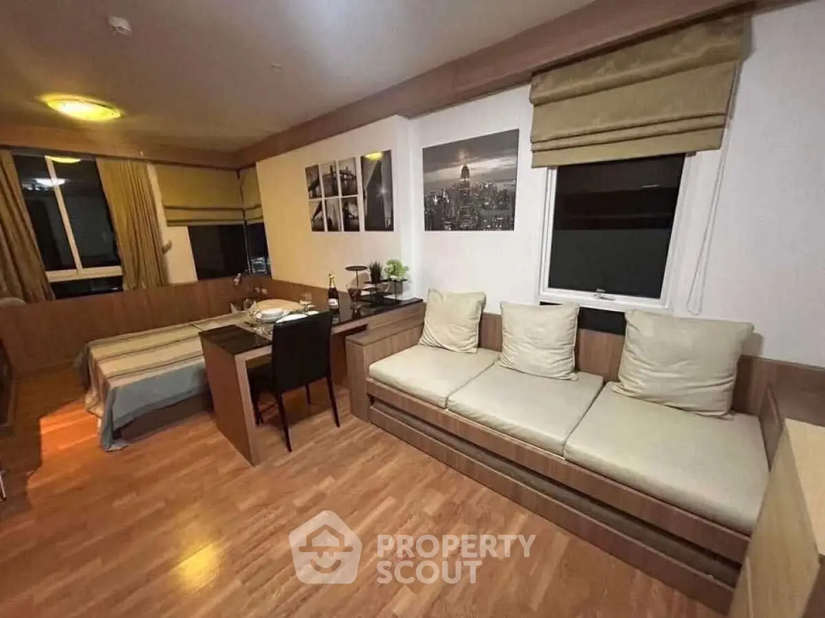 Cozy studio apartment with modern decor and wooden flooring