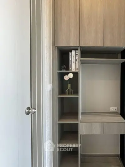 Modern storage unit with sleek wooden cabinets and decorative elements in a stylish interior.