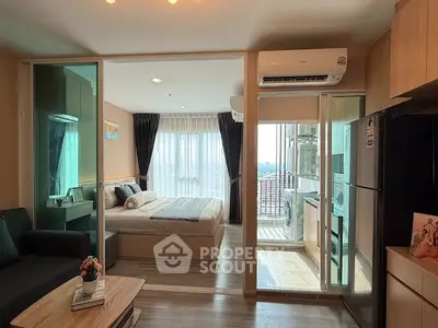 Modern apartment interior with bedroom, living area, and balcony view