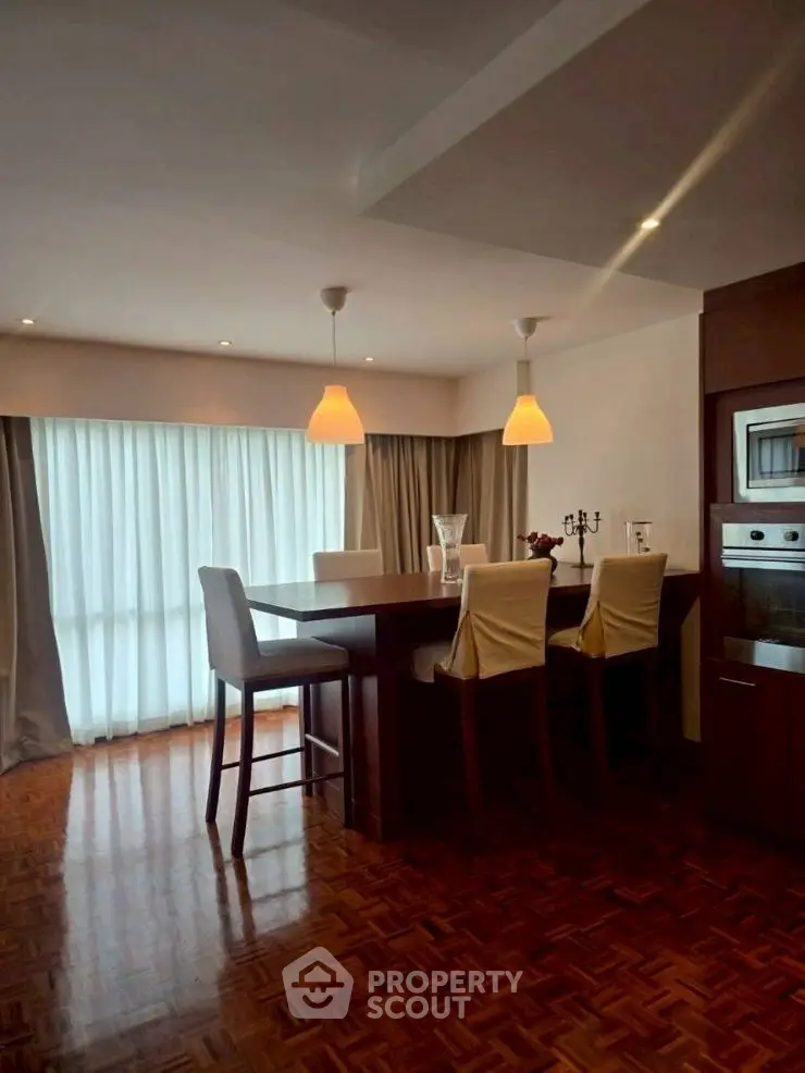 Elegant dining area with modern lighting and parquet flooring