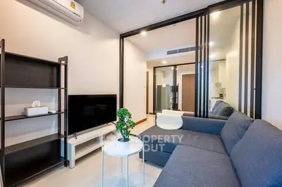 Modern living room with sleek furniture and air conditioning in a stylish apartment.