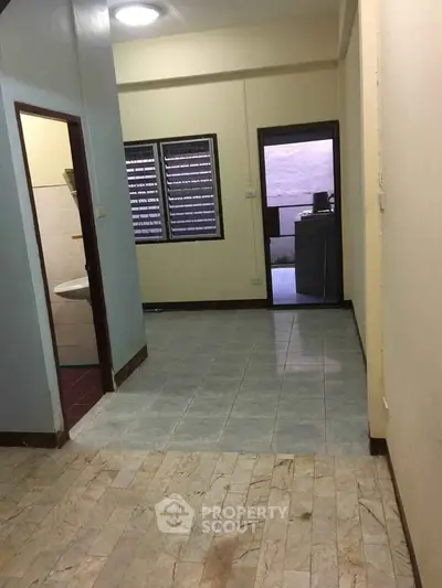 Spacious interior with tiled flooring and natural light, ideal for customization.