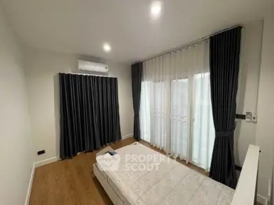 Modern minimalist bedroom with floor-to-ceiling windows and elegant curtains.