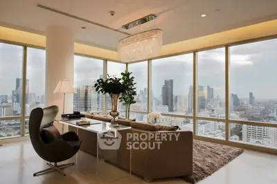 Luxurious living room with panoramic city views and elegant decor in high-rise apartment.