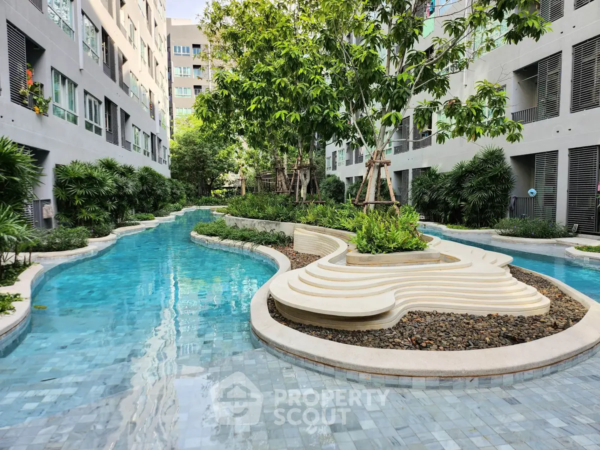 Luxurious apartment complex with stunning outdoor pool and lush greenery