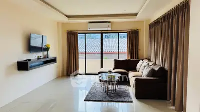 Spacious living room with modern decor and large windows for natural light.