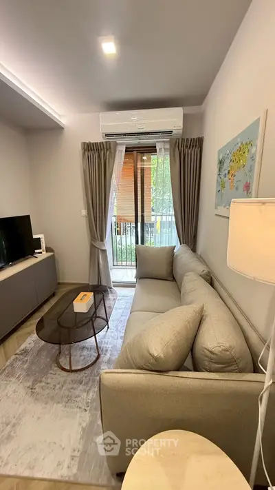 Modern living room with cozy gray sofa and balcony view