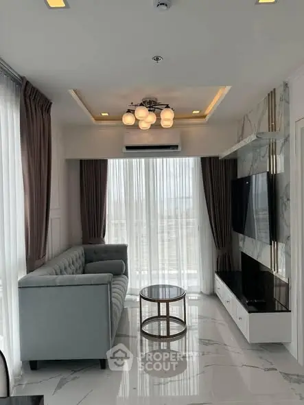 Luxurious modern living room with elegant decor and large windows.