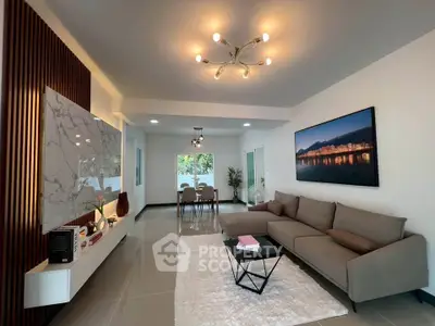Modern living room with stylish decor and open layout, featuring a cozy sofa and elegant lighting.