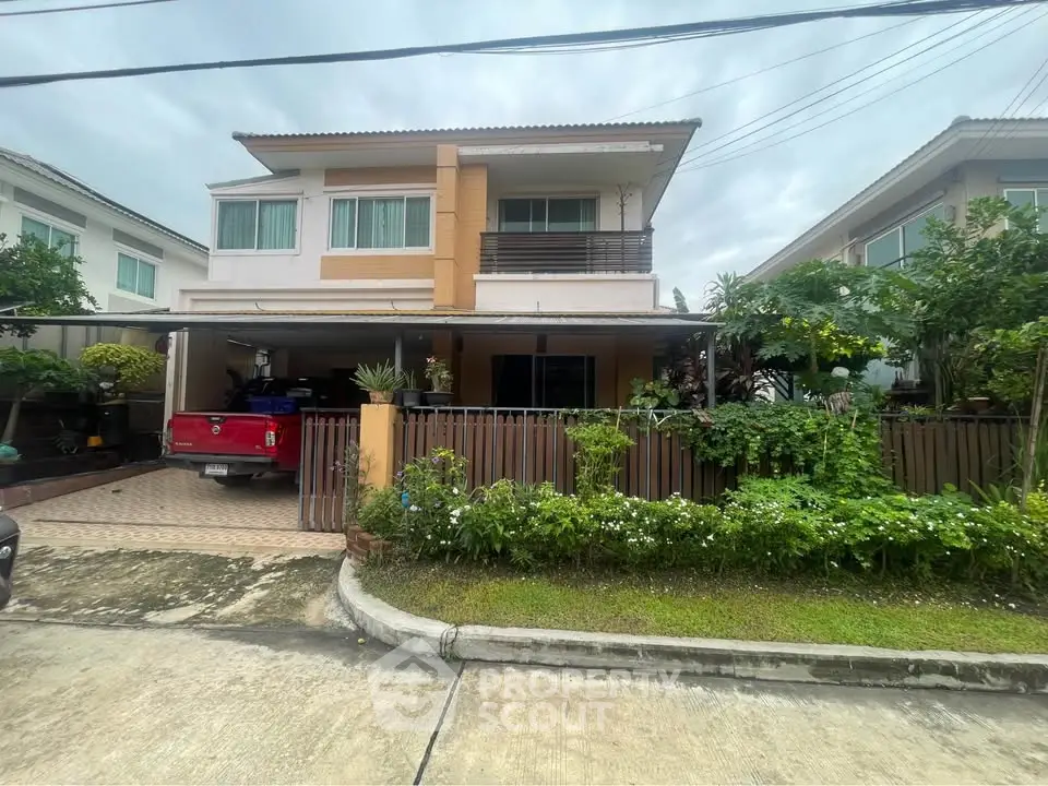 Charming two-story house with lush garden and spacious driveway in a serene neighborhood.