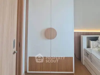 Modern bedroom with stylish wardrobe and wooden accents