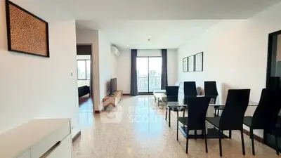 Spacious modern living room with dining area and city view, perfect for urban living.