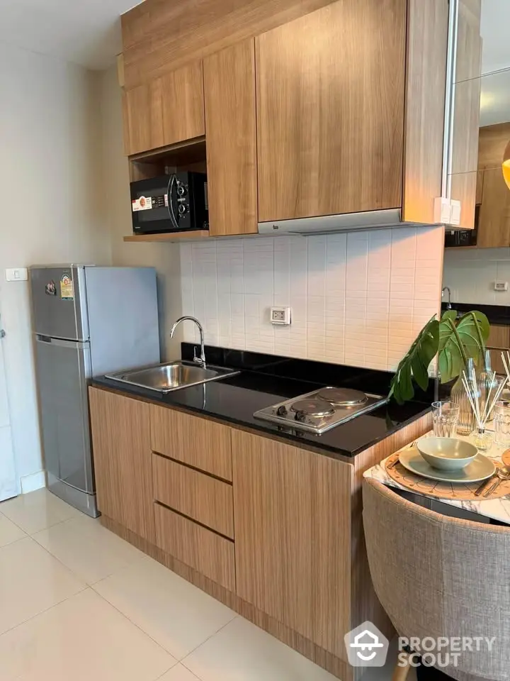 Modern kitchen with sleek wooden cabinets and stainless steel appliances