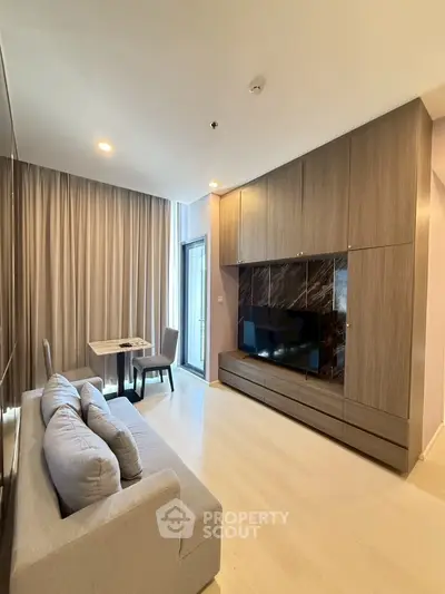 Modern living room with sleek wooden cabinetry and cozy seating area.