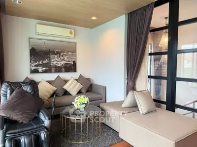 Stylish living room with modern furniture and elegant decor in a cozy apartment setting.